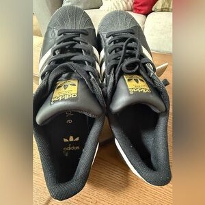 adidas Superstar Black Sneakers with White Stripes and Gold Tongue Logo